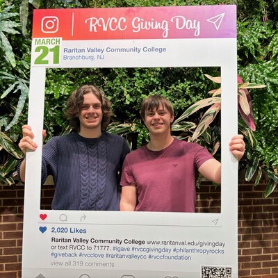 2 male students in giving day selfie booth
