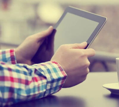 student with a tablet and coffee