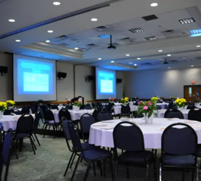 Grand Conference room set up with tables and video screens