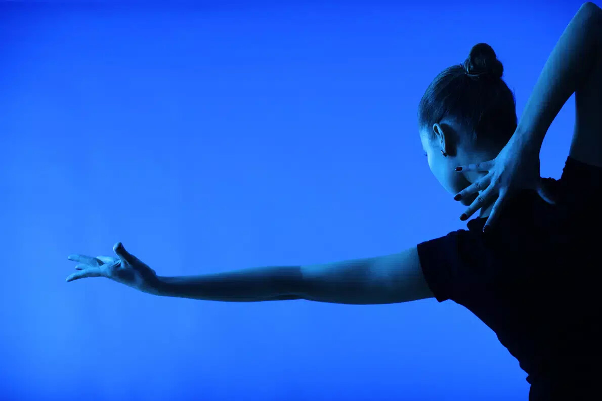 female dancer from the back wearing dark nail polish