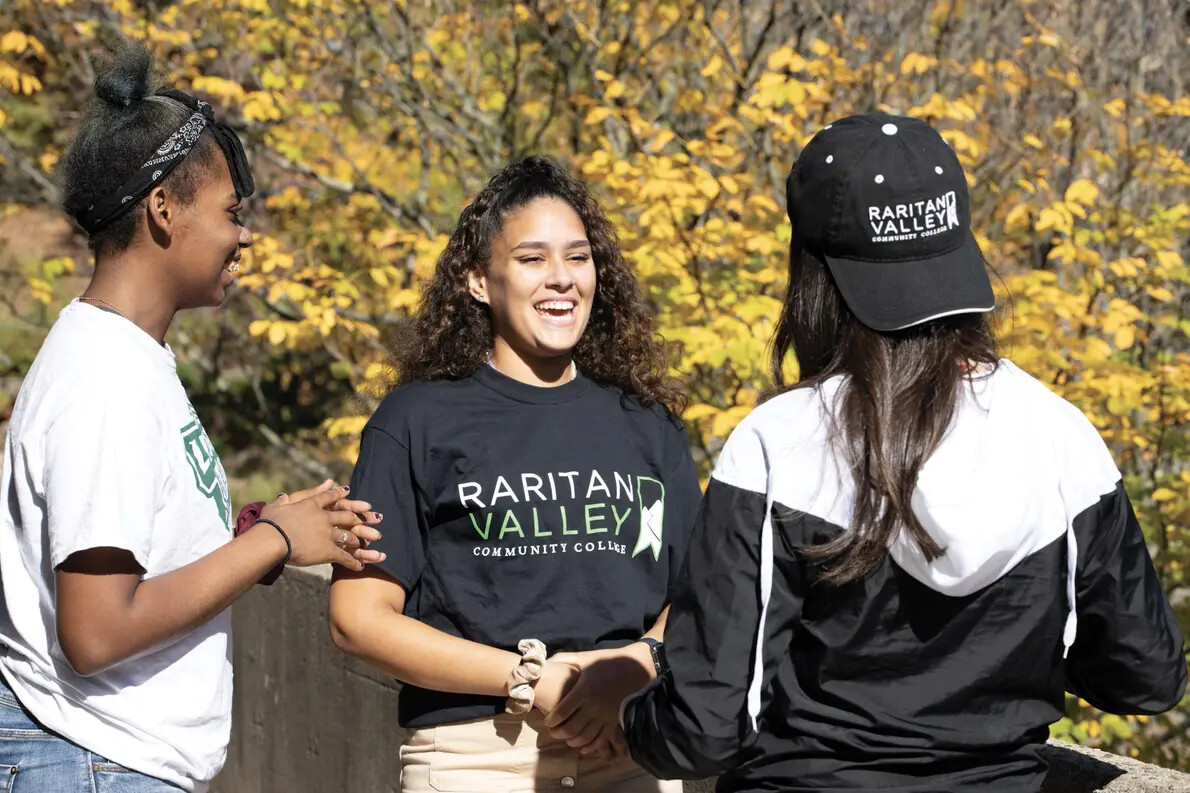 girl with rvcc t-shirt next to 2 girls with side and back to camera