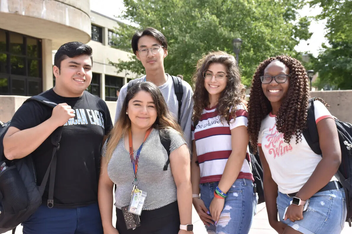 group of five students outside