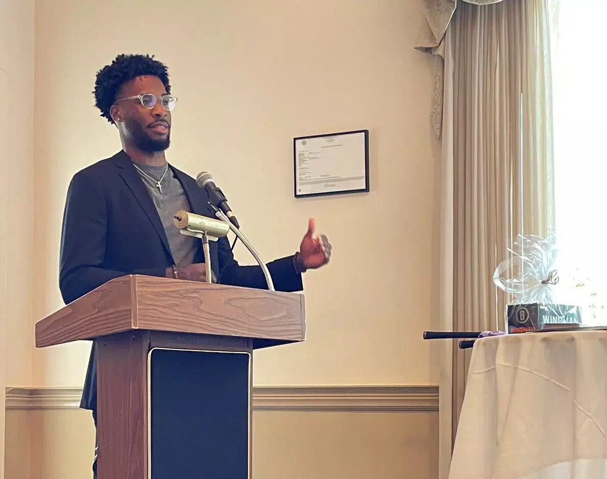 male student malachi white at podium