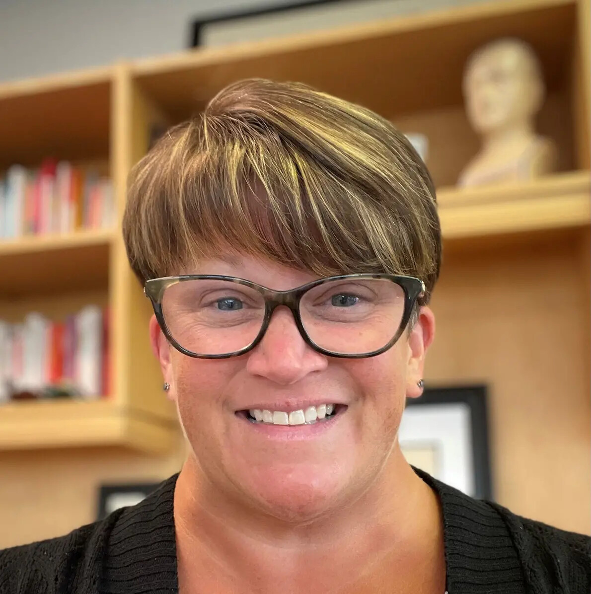 karen bearce with bookshelves behind her