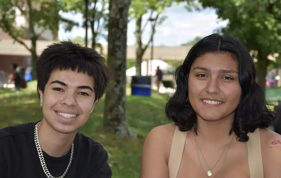 girl with necklace and girl with beige top outside