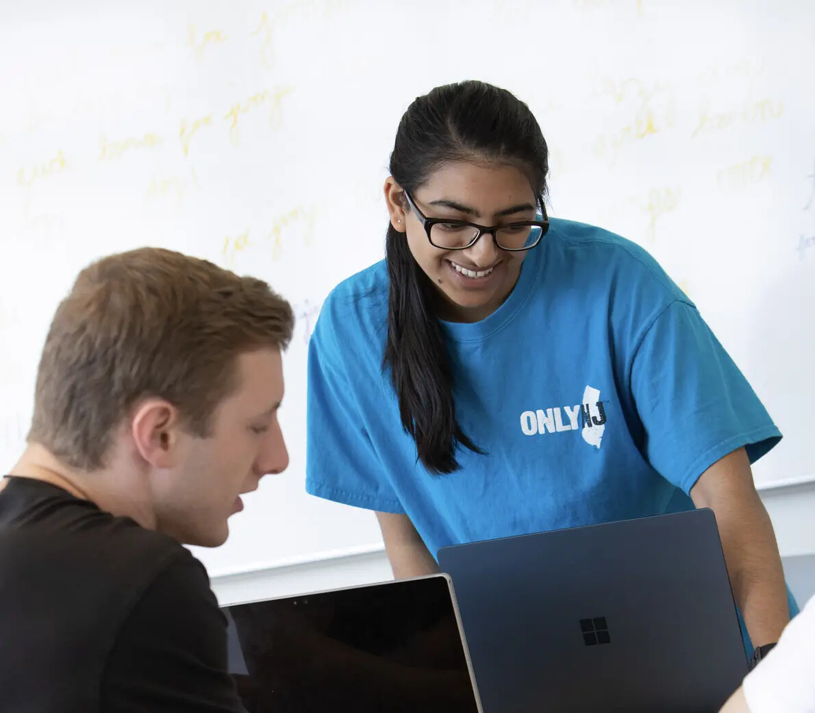 girl with glass and blue shirt and boy with laptop