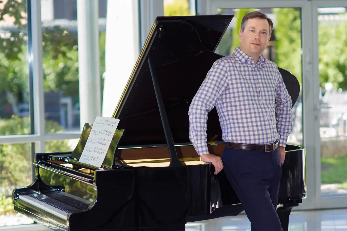 pianist morozov standing in front of piano