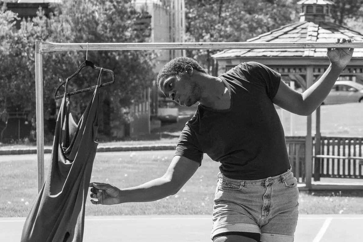 black and white photo of male dancer outside