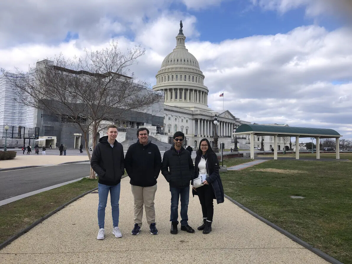 four honors college students with capitol  in background