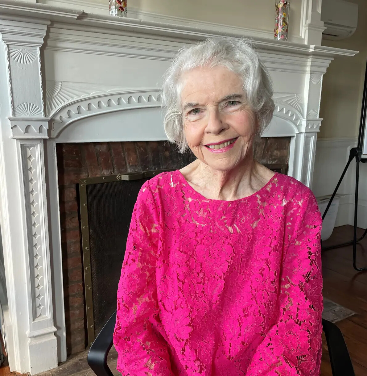 elisabeth mcconville in front of fireplace