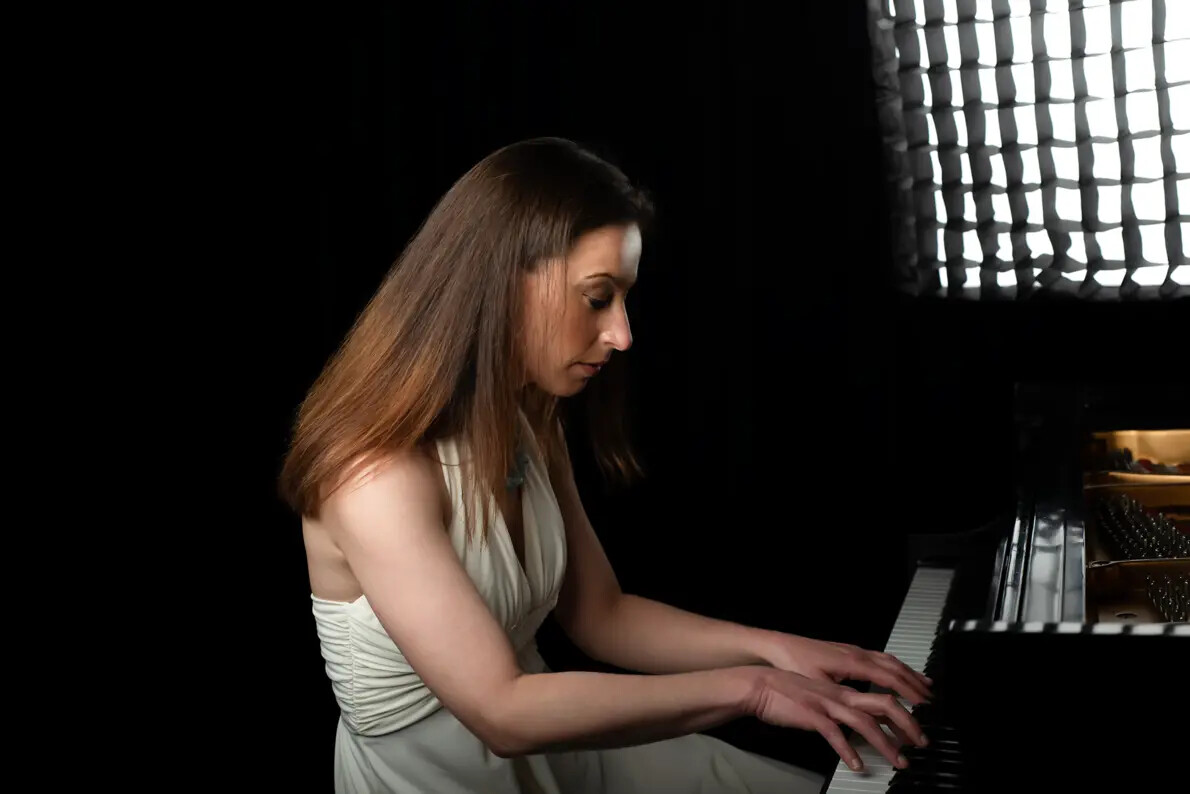 side view of anna keiserman playing piano