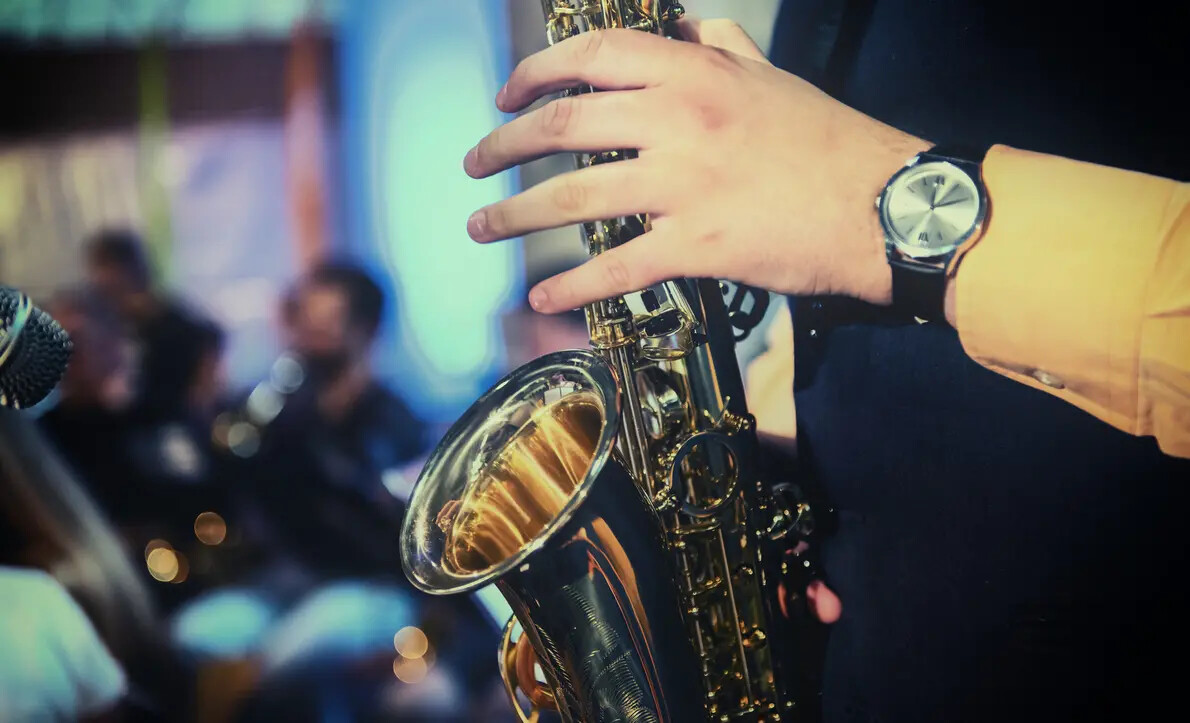 hand wearing watch playing sax