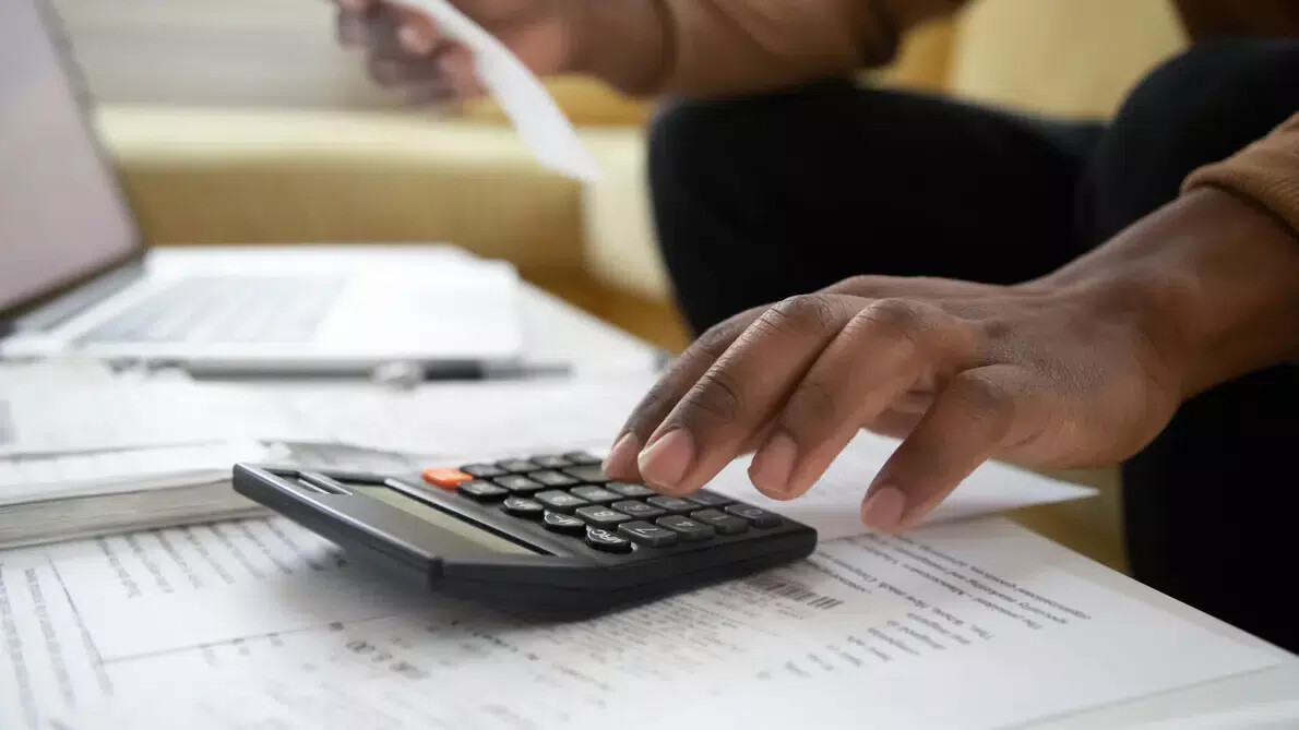 close up of man's hand on calculator