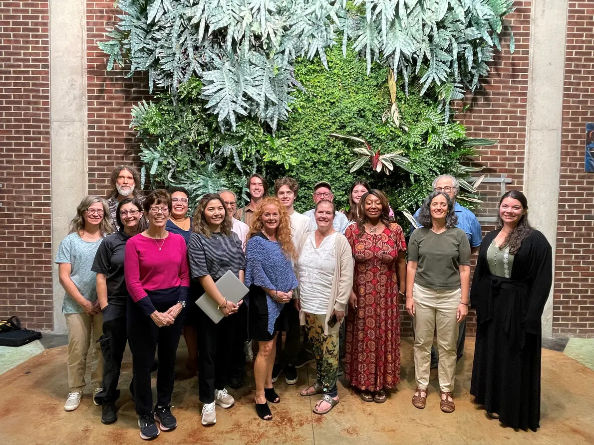 group in front of green wall