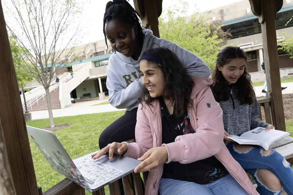 3 female students studying in gazebo outside