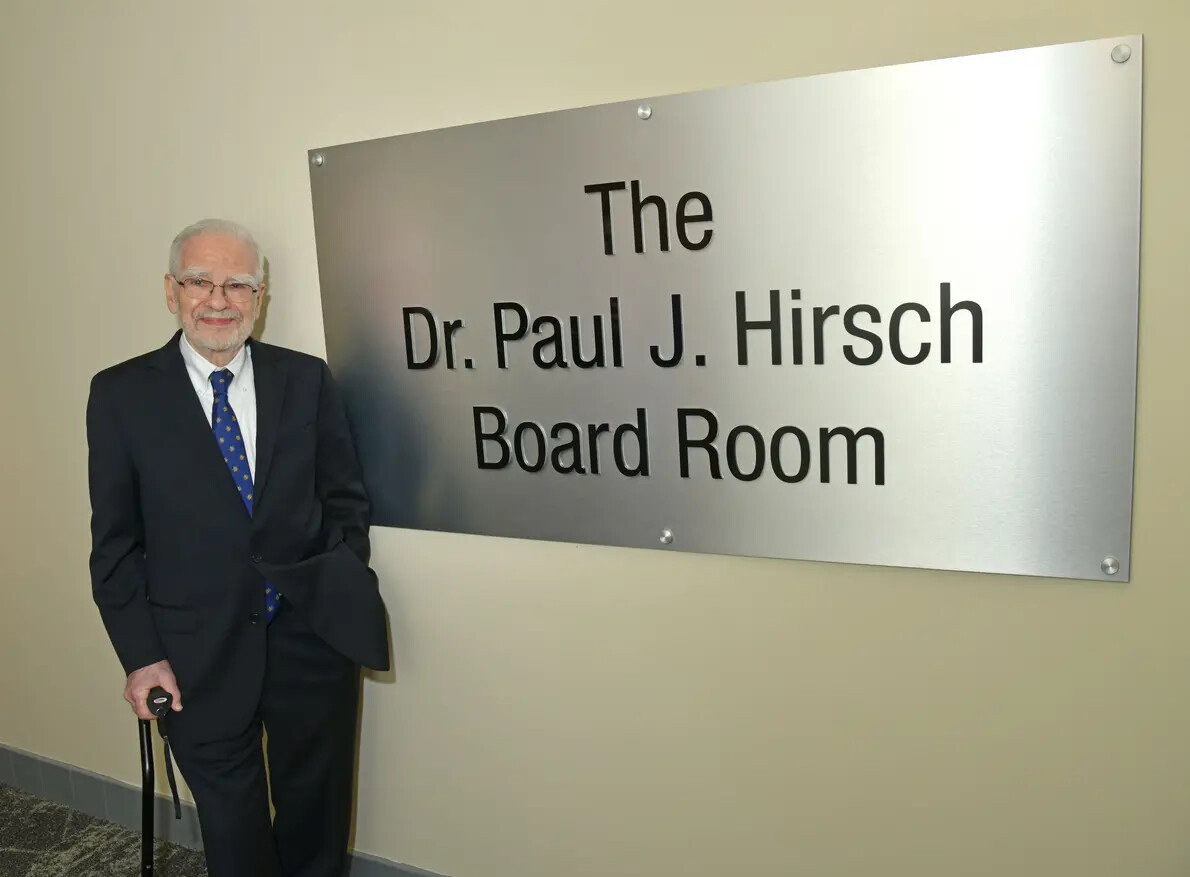 paul hirsch with sign with his name