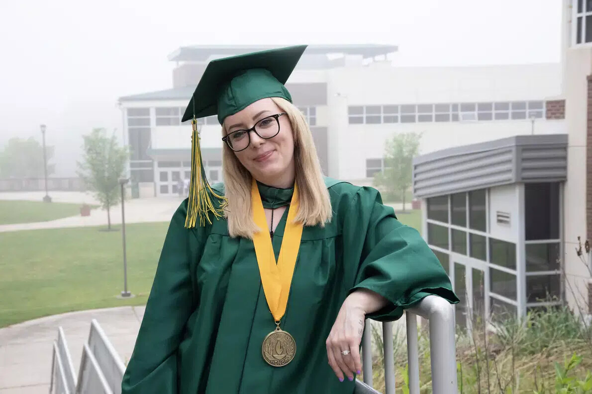 blond older female grad with glasses