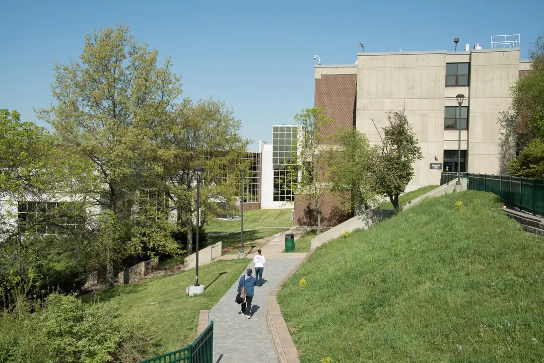 students from back walking on path with view of rvcc buildings