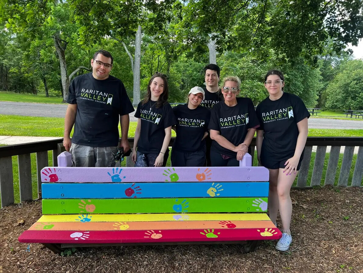 OTA students behind brightly painted bench