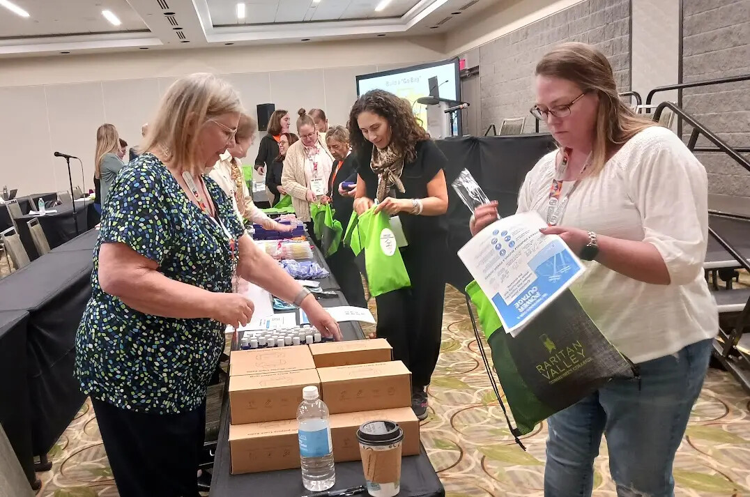 people preparing bags of stuff in conference room