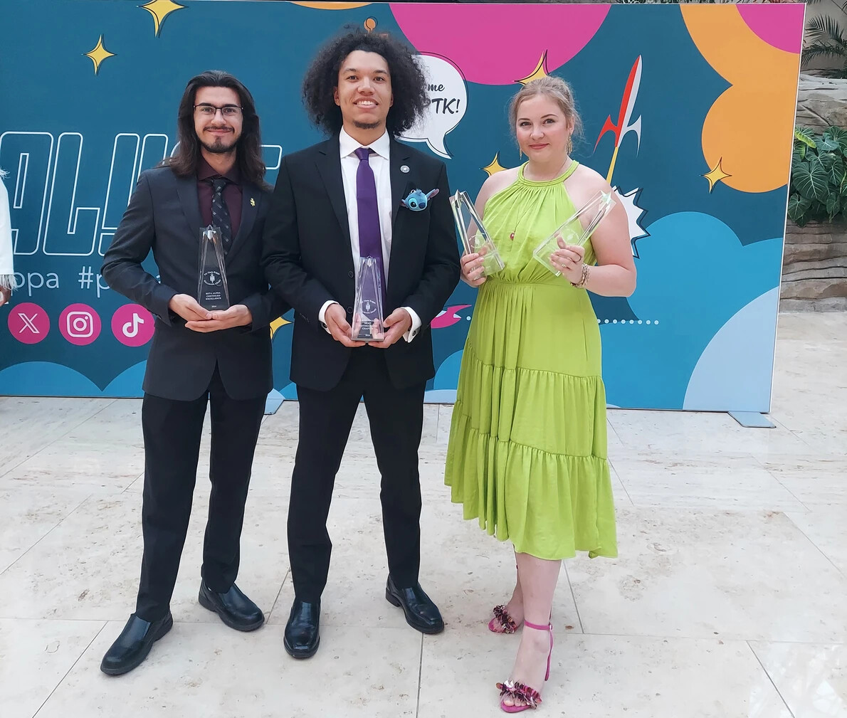 3 ptk officers holding trophies