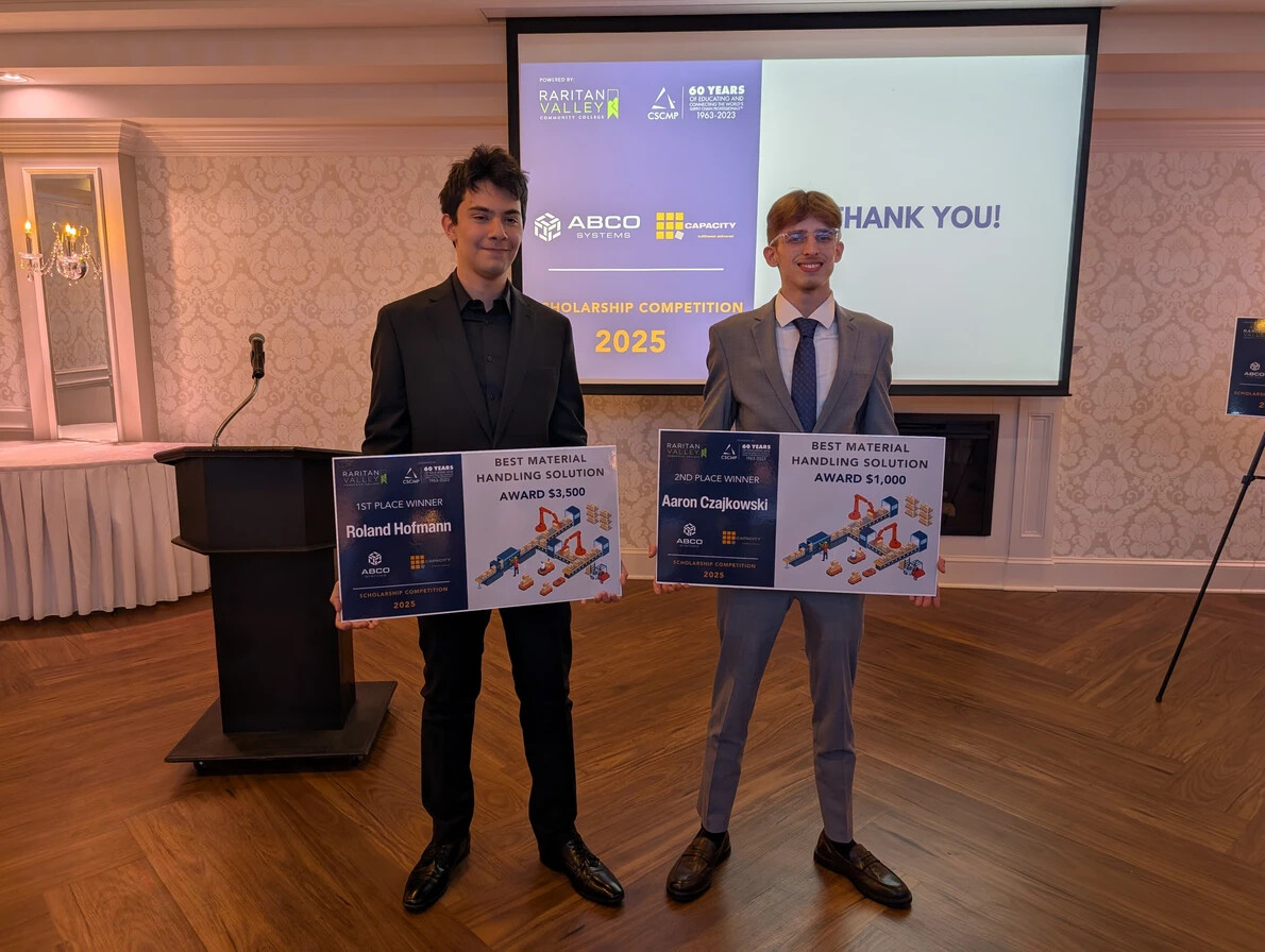 students holding scholarship contest posters