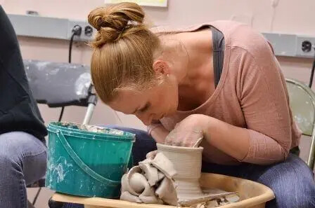 Ceramics student on pottery wheel