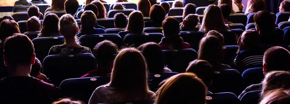 backs of audience members