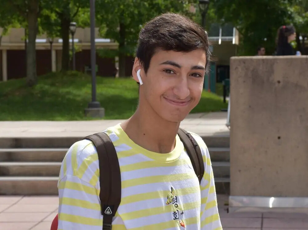 boy outside with yellow striped shirt