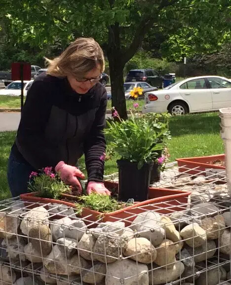 woman planting in enabling garden