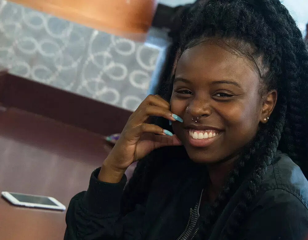 smiling girl with long blue nails