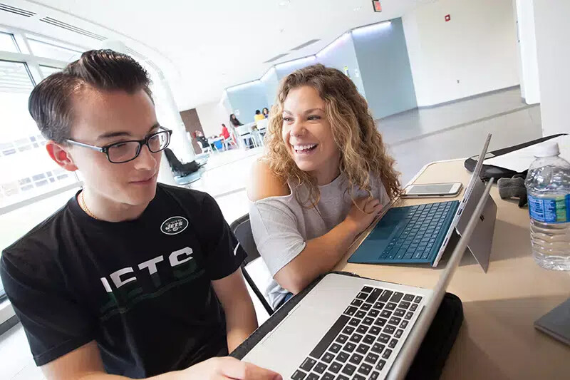 male and female student in science center addition