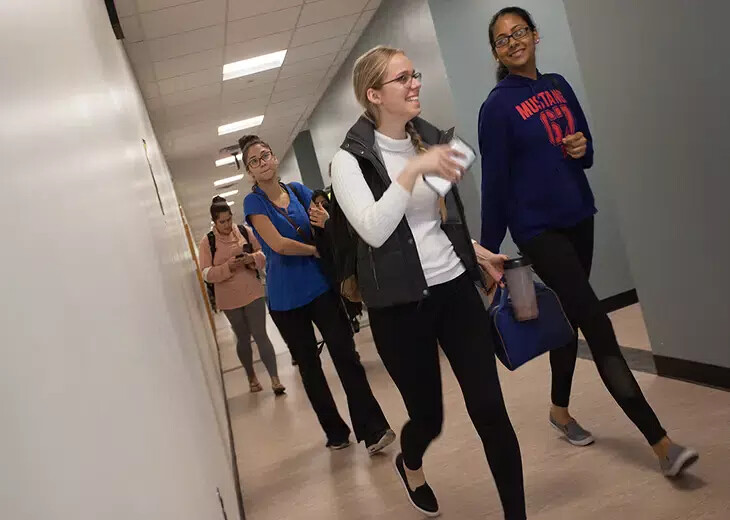 angular view of female students walking in hallway