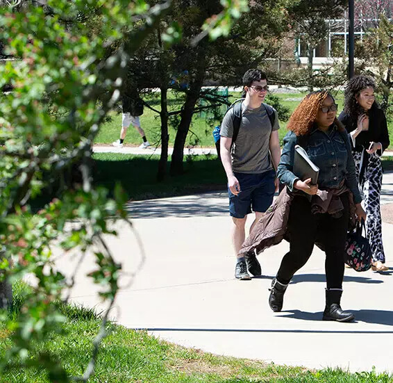 3 grads walking outside