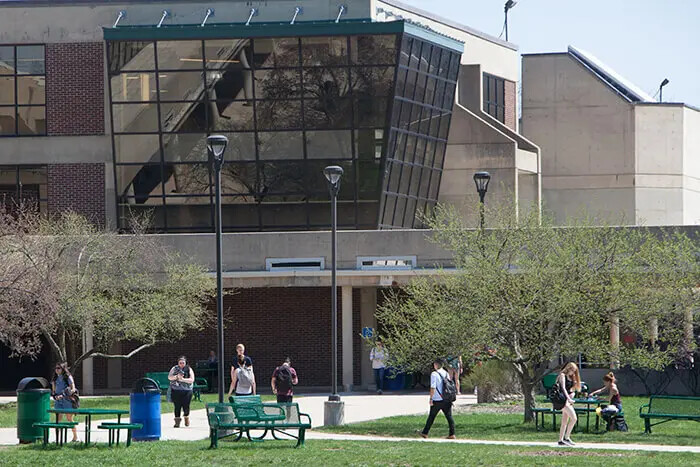 students walking with cafeteria in background