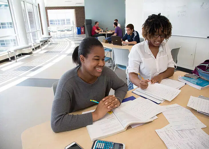 female students in science building lobby