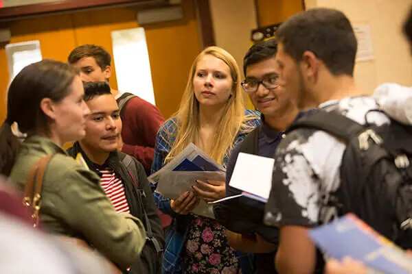 students huddled and chatting