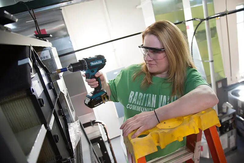 female hvac student at work