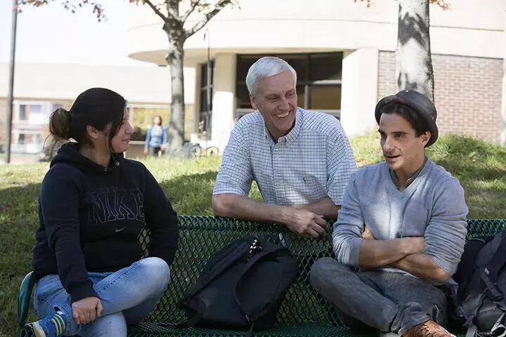 bill klinger outside with female student and mail student wearing hat