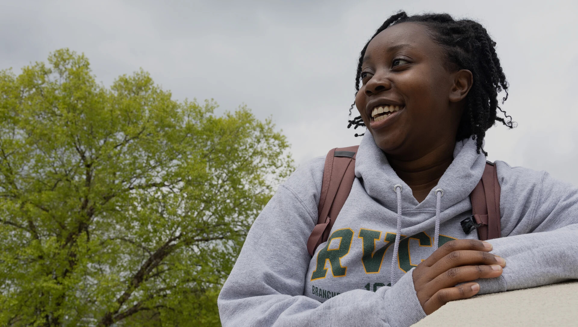 female student in RVCC sweatshirt outside