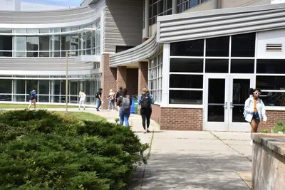 students walking outside near science building