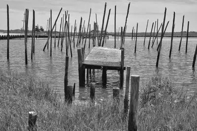 black and white photo of dock in water