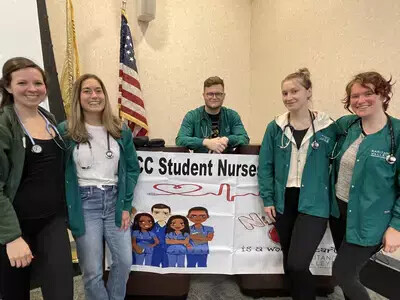 student nurses with poster