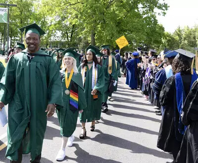 graduates walking through line of faculty