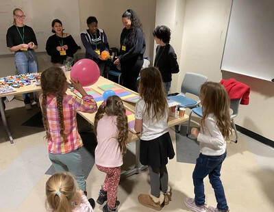 students and kids doing experiment with balloons