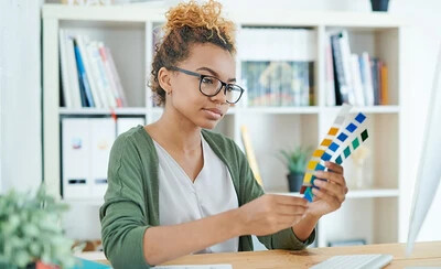 student examining color swatches