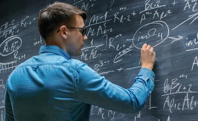 science tech worker at chalkboard