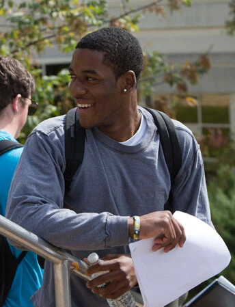 rvcc student on stairs with paper in hand