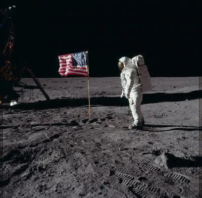astronaut on moon with american flag