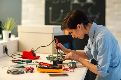 woman soldering circuit board